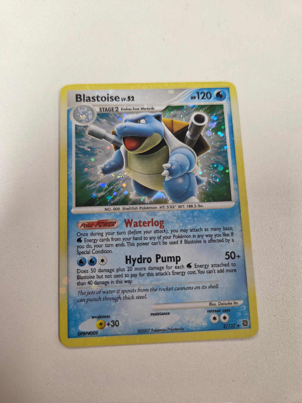 Blastoise (2)/132 Bleed Holo error with spiral on bottom left (Cabinet-LP)