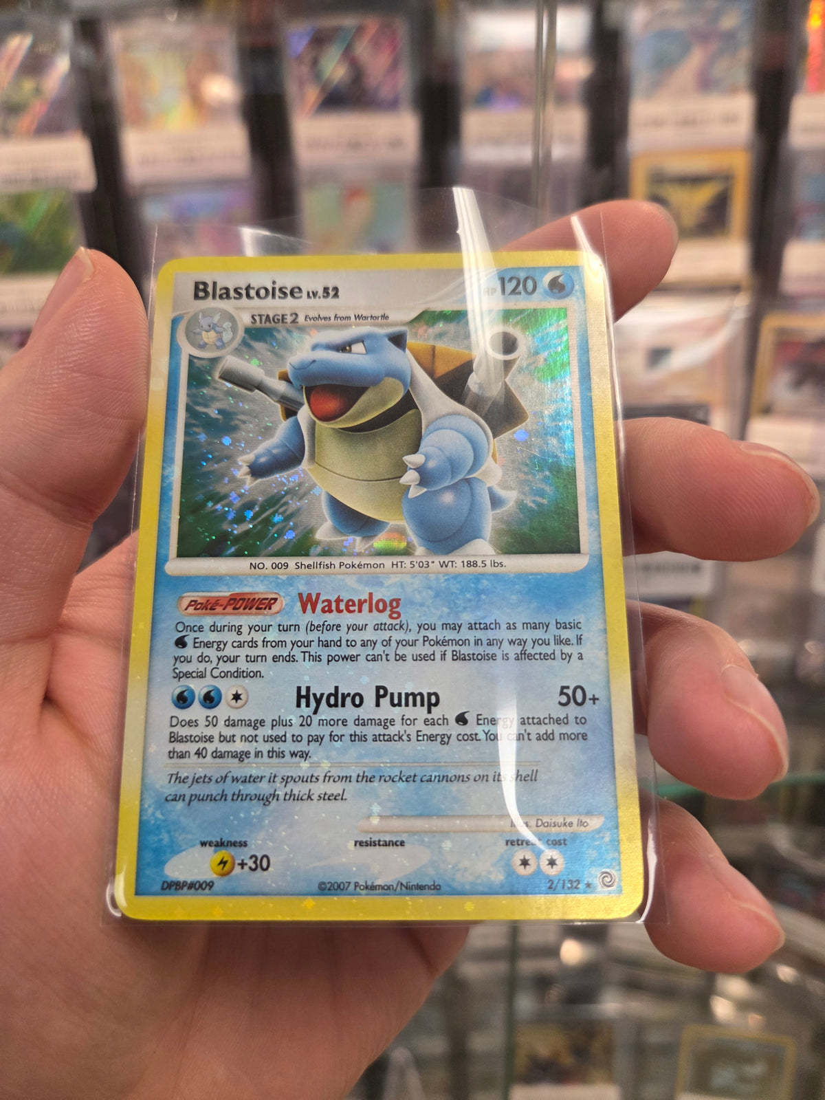 Blastoise (2)/132 Bleed Holo error with spiral on bottom left (Cabinet-LP)